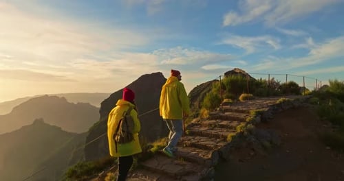 Couple Hiking on Mountain at Sunrise