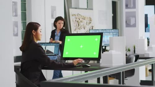Architect Using Computer with Greenscreen at Workstation