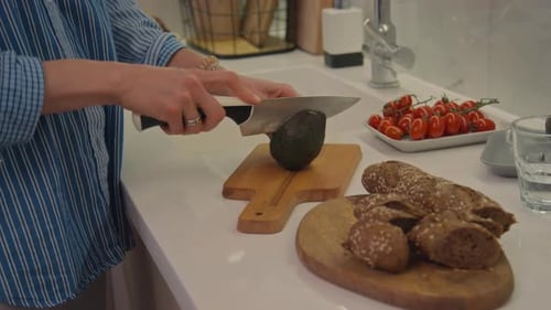 Cutting Fresh Avocado in Bright Kitchen