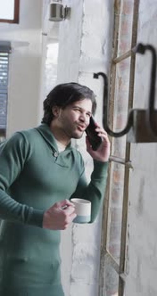 Man Talking on Cell Phone with Coffee