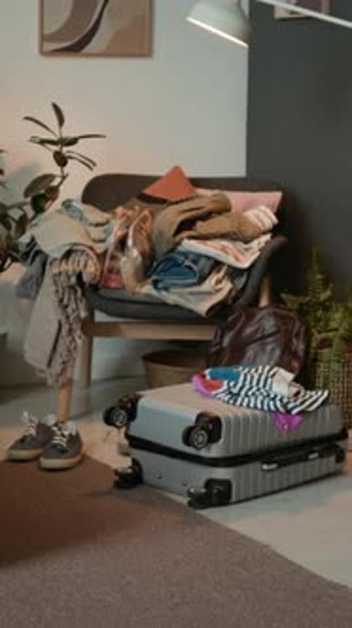 Valise verticale sur le sol de la chambre à coucher et ensemble de vêtements de voyage