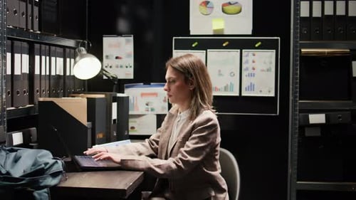 Woman Working Diligently in a Small Office