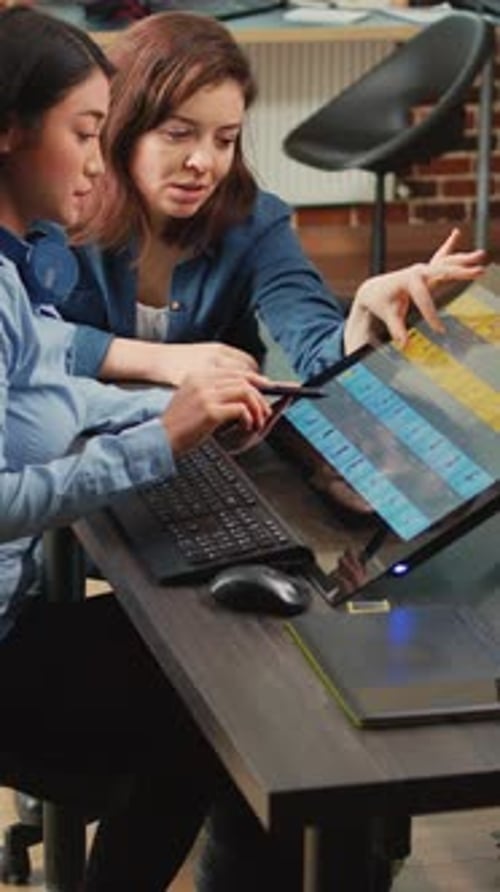 Women Working Collaboratively on a Digital Display Screen