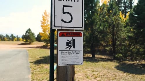 Speed Limit And Warning Signs At The Gate Post. close up, tilt-up