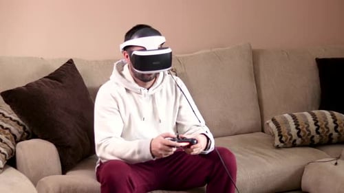 Man Immersed in Virtual Reality Gaming at Home