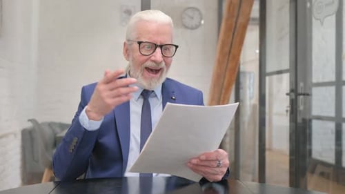 Man Celebrating Good News About Document He's Reading