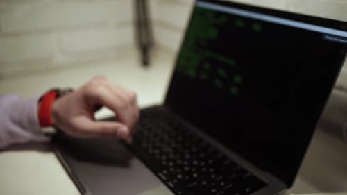 Hands Typing Code on Laptop Keyboard