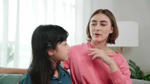 Woman and Child Chatting Indoors on Sofa