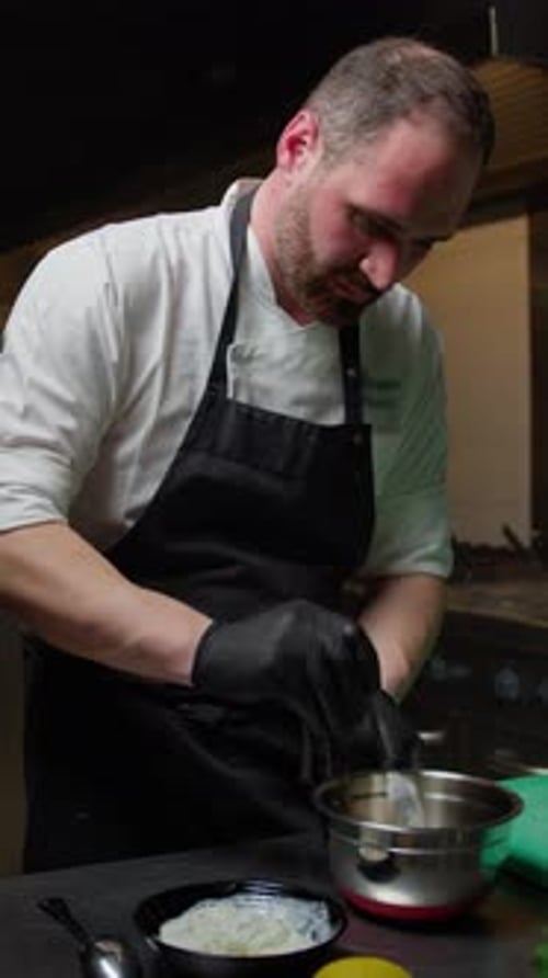 Chef Prepares Creamy White Sauce in Commercial Kitchen
