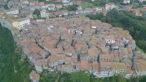 Aerial view of a medieval town in Italy, the drone camera tilts down