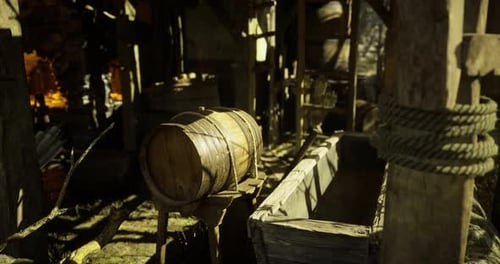 Rustic Wooden Barrel and Empty Trough Inside a Farm Shed