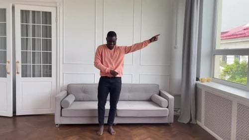Young Adult Man Dancing Barefoot at Home