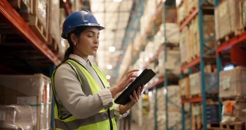 Woman Using Tablet in Brightly Lit Warehouse