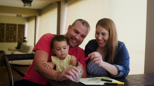 Loving Family Enjoying Coloring Together at Home