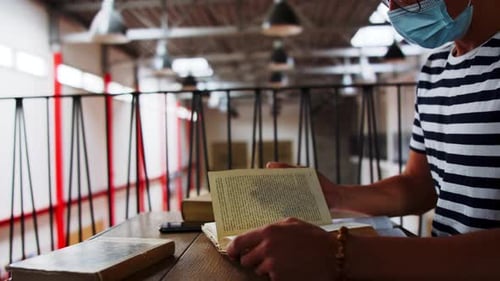 Young students study safely with face masks at university during coronavirus pandemic