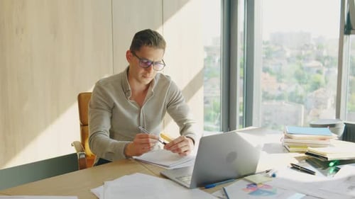 In a Modern Office a Professional is Dedicated to Thorough Documentation Displaying Resilience The