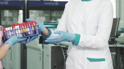 Medical Professional Receives Lab Samples in Modern Lab