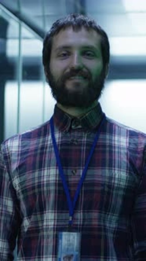 Adult Man Smiling in a Modern Server Room