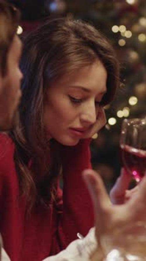 Woman with Wine Glass at Christmas Table
