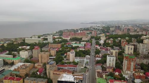 An Aerial View Showcasing a Coastal Cityscape Beneath a Beautifully Overcast Sky Stock Clip