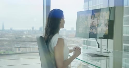 Woman Attending Virtual Meeting in Modern Office