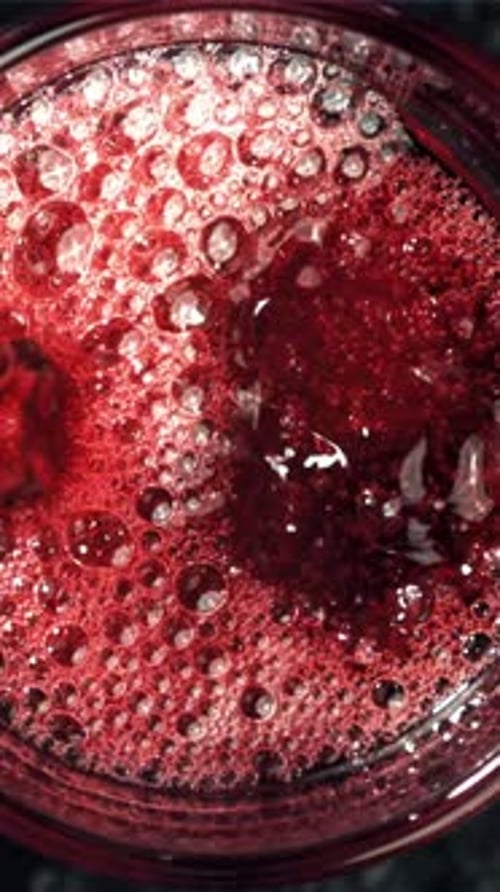 Red Wine is Poured Into a Glass Top View Filmed on a Highspeed Camera at 1000 Fps