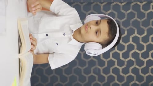 Joyful Child Dancing at Desk with Headphones