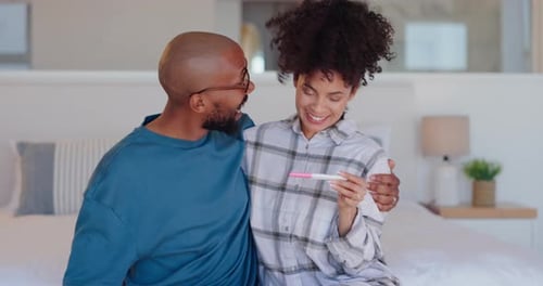 Excited Couple Celebrating Positive Pregnancy Test Results