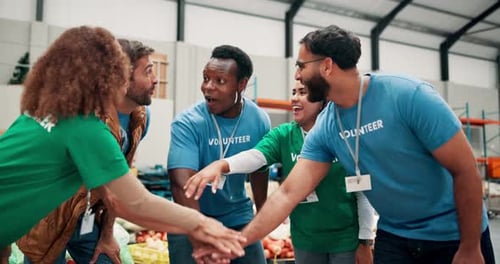 Volunteers Cheering Together in Warehouse Setting