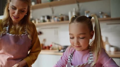 Curious Kid Rolling Dough on Table Apartment Closeup Mother Teach Daughter Bake