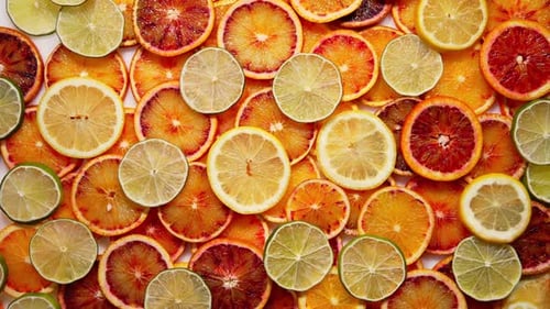 Sliced Citrus Fruit with Light Lemon Orange Mandarin Grapefruit Background