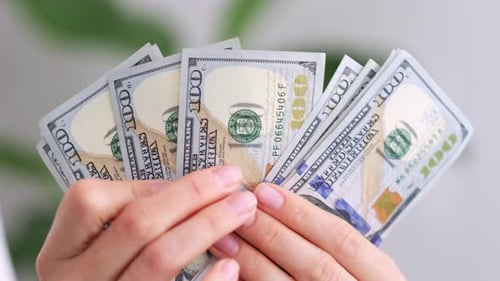 Excited Woman Showing Cash Money 1000 American Dollars Banknotes Hands with Money Close Up Income