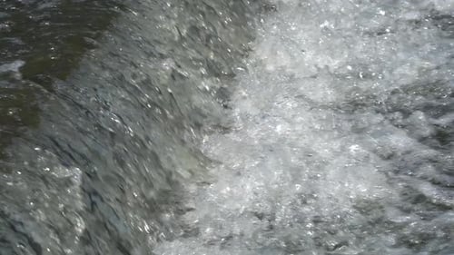 Water stream running down the slope, rapid water motion waterfall