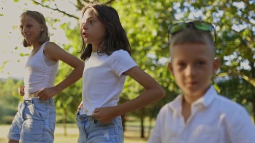 Children Playing and Running in Park with Father
