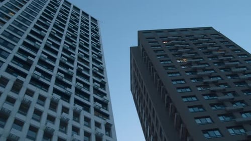 Low angle view of a multi storey building on blue sky background