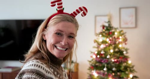 Woman Drinking Hot Chocolate by Christmas Tree