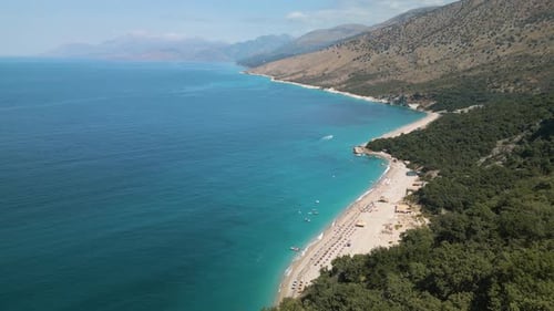 High drone dolly above clear blue ocean water crashing on beautiful sandy tropical resort beaches