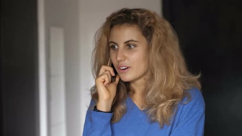 beautiful young woman talking on the phone with a friend of hers