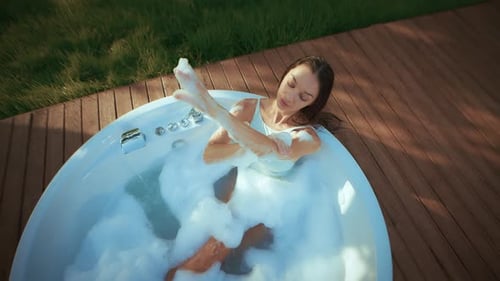 Woman Relaxing in Bubbly Outdoor Hot Tub