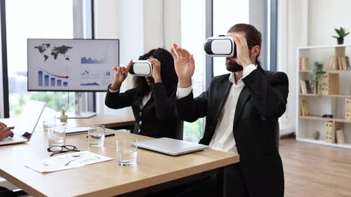 Business Professionals Using Virtual Reality Headsets in Modern Office