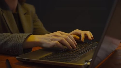 Close Up of Adult Typing on Laptop Computer