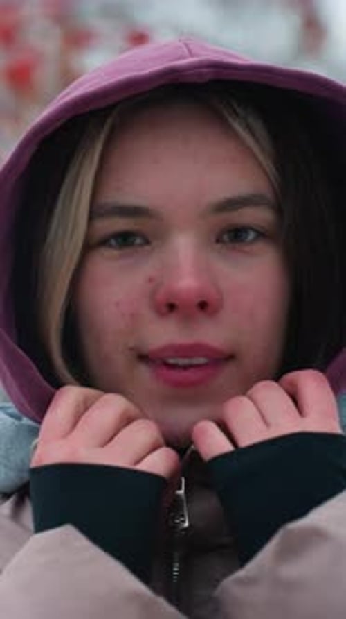 Teenage Girl with Hood Up Smiling in Winter