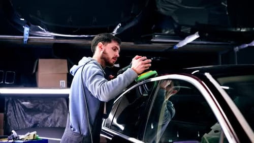the Car Mechanic at a Service Station Doing the Final Polishing to Shine