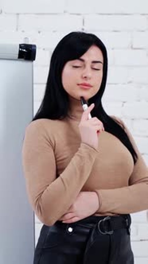 Woman near board. Portrait of young beautiful business woman in the office