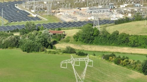 Transmission Towers And Photovoltaic Power Plant In Italy. aerial tilt-up shot