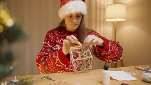 Woman Crafts Christmas Ornament at Home