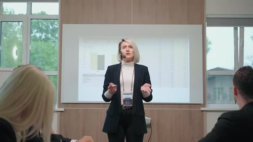 Woman Business Coach is Speaking in Front of Young Specialists and Businesspeople Education