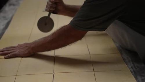 artisan bakery, baker making bread and pastry, dough kneading, baker cutting dough on table