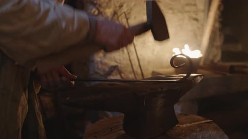 Blacksmith Working Metal on Anvil in Workshop