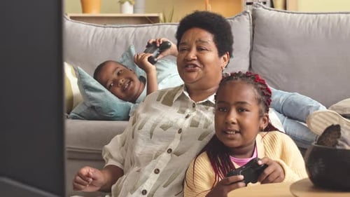 Family Having Fun Playing Video Games at Home